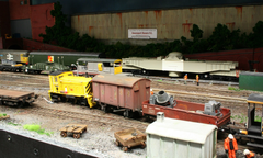 PWM Shunter 97652 on a short departmental train, whilst an MOD nuclear flask train exits the dockyard.